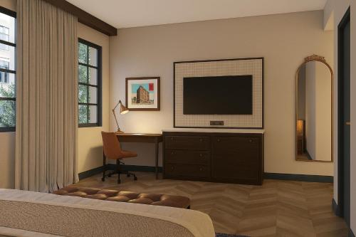 a bedroom with a television and a desk with a chair at Hampton Inn & Suites Birmingham-Downtown-Tutwiler in Birmingham