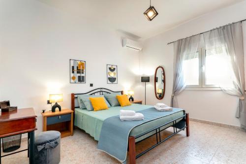 a bedroom with a bed and a desk and a window at Aquarius View in Archipolis