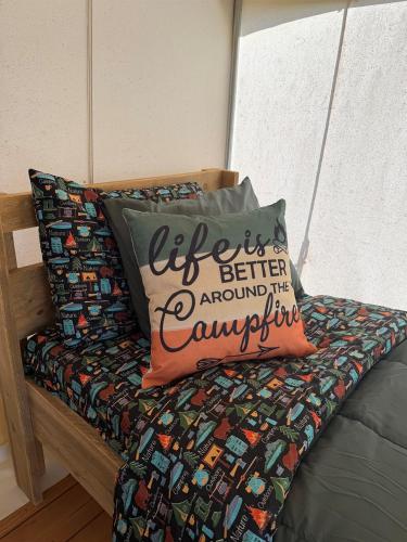 a bed with a pillow that says better around thecountry at Peaceful Glamping Retreat at Roaring River in Cassville