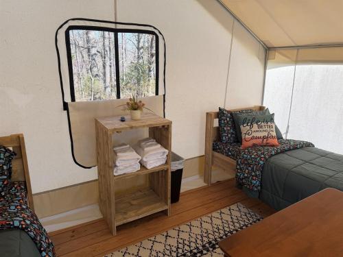 a room with a bed and a window at Peaceful Glamping Retreat at Roaring River in Cassville