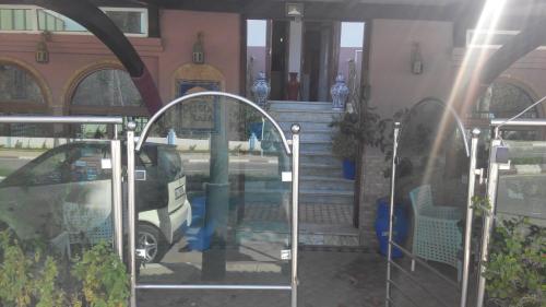 a car is parked in front of a building at Pasta Plaza in Asilah