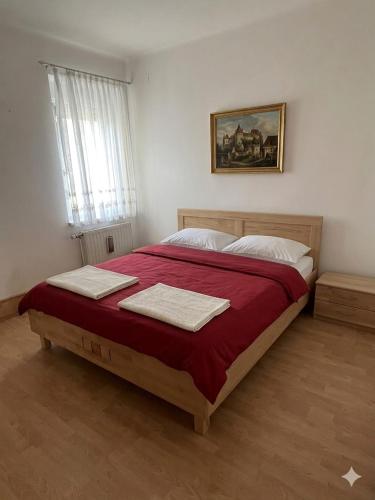 a bedroom with a large bed with two towels on it at Stratos Apartments in Laa an der Thaya