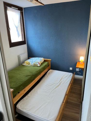 a small room with two bunk beds and a window at EcrAin Montagnard in Lélex