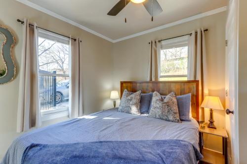 a bedroom with a blue bed and a window at Lakefront Eucha Escape w/ Views & Boat Slip! in Eucha