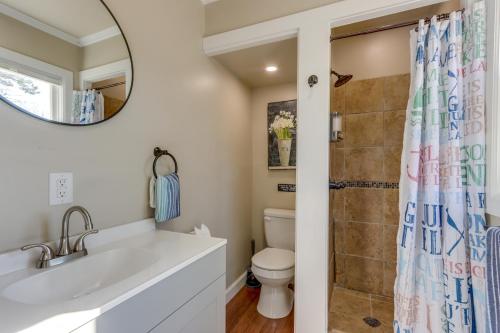 a bathroom with a toilet and a sink and a mirror at Lakefront Eucha Escape w/ Views & Boat Slip! in Eucha