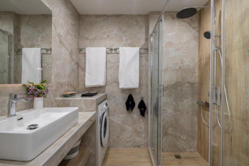 a bathroom with a sink and a shower at Casa Angelica in Patitiri