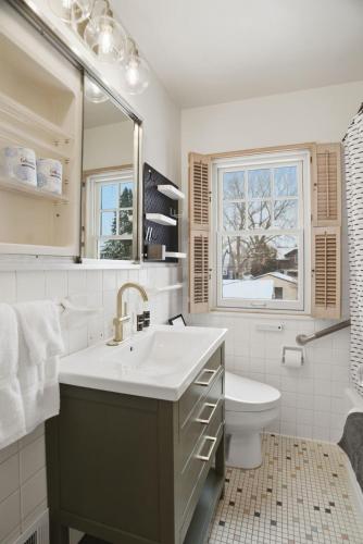 a bathroom with a sink and a toilet and a window at Como Classic in Saint Paul