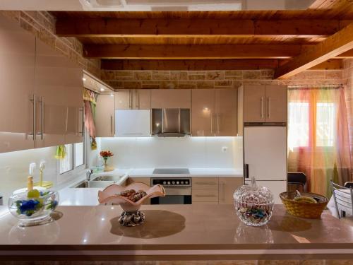 a kitchen with a table with a counter top at Villa Erato Keratea in Keratea