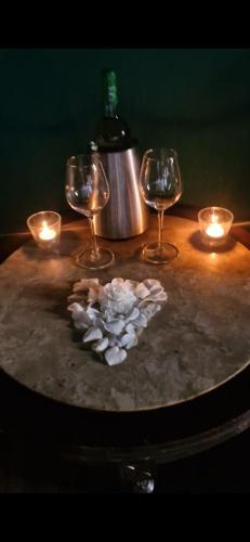 a table with wine glasses and a heart made of flowers at 4-5 star Ecoresort Portobali in Jugueiros