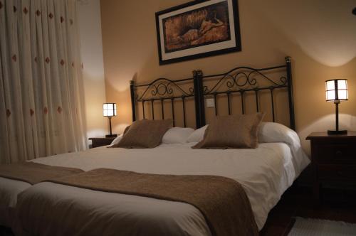 a bedroom with a large bed with two pillows at CASA RURAL LA IBIENZA in Zarzuela del Pinar