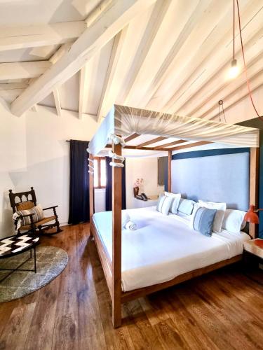a bedroom with a large bed with a canopy at Lluna Aqua Soller - Adults Recommended in Sóller