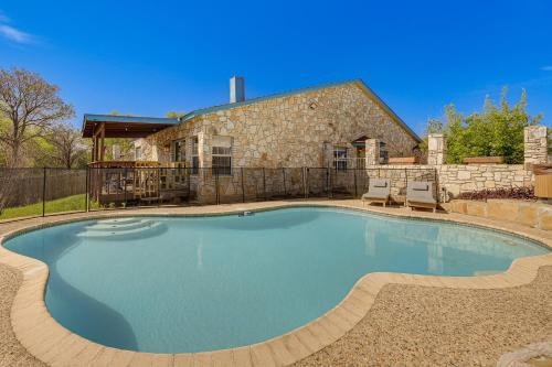 a large swimming pool in front of a house at San Antonio Retreat with Fenced Pool, Near SeaWorld in San Antonio