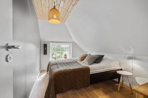 a bedroom with a bed in a white room at BV264-Blavand-Solhaven-47 in Blåvand