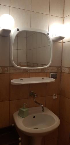 a bathroom with a sink and a mirror on the wall at LeśnyZakątekNysa in Skorochow