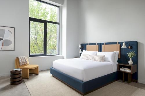 a bedroom with a large bed and a window at The Neighborhood Hotel - Little Italy Studio in Chicago