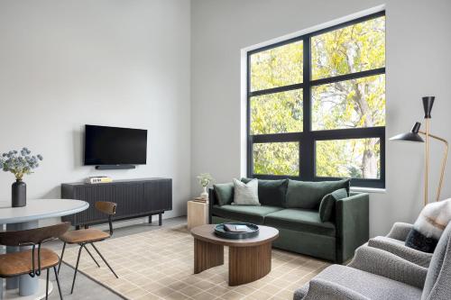 a living room with a couch and a table at The Neighborhood Hotel - Little Italy Studio in Chicago