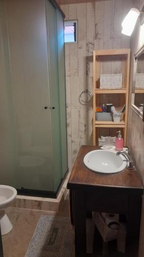 a bathroom with a sink and a glass shower at La Su in Duggan