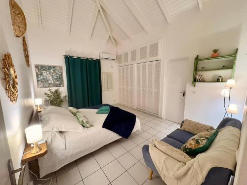 a bedroom with two beds and a couch in it at Villa Eli -6pers- piscine in Petit-Bourg