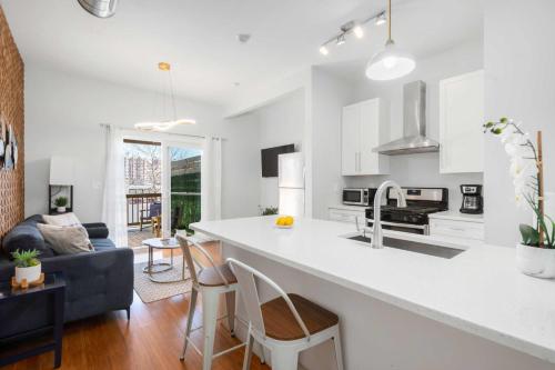 a kitchen and living room with a white counter top at Jennifer's Chic 2nd Floor Apt Private Deck w Views in Providence