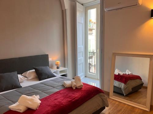 a bedroom with a large bed and a mirror at Hely's House in Naples