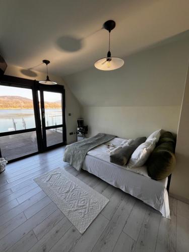 a bedroom with a bed with pillows on it at RestOnTheLake in Esztergom