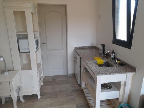 a kitchen with a sink and a counter top at Aguamansa Apart in Potrero de los Funes