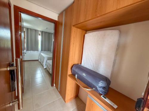 a room with a chair in a room with a bedroom at Kariri beach apt 427 Praia do Cumbuco in Cumbuco