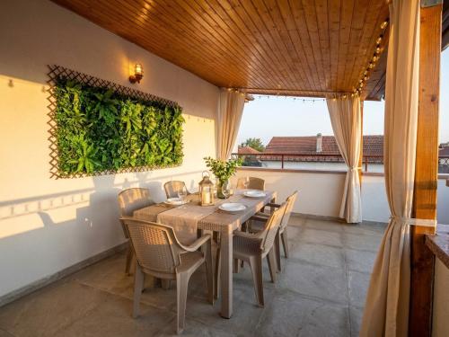 a dining room with a table and chairs at Serenity Apartments and Studios in Eforie Nord