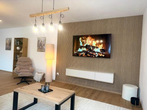 a living room with a fire on the wall at Apartmán SteMa Home in Františkovy Lázně