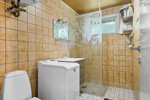 a bathroom with a toilet and a sink at 198-Ringkobing-Bogealle-8 in Nørby