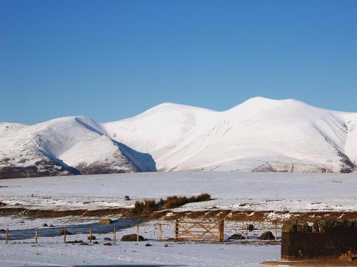 a snowy mountain range with mountains in the background at Garries Cottage in Bassenthwaite