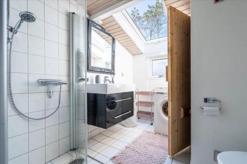 a bathroom with a shower and a sink and a toilet at 156-Ringkobing-Birkealle-14 in Nørby