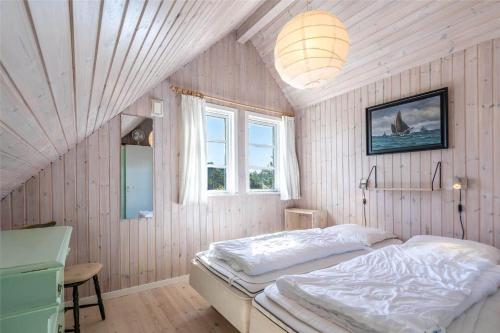 a bedroom with a bed and a window in it at 221-Ringkobing-Havklitvej-72 in Klegod