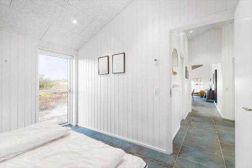 a white room with a bed and a hallway at 1157-Ringkobing-Frans-Julius-Vej-7 in Klegod