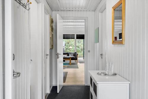 a hallway with a door leading to a living room at 265-Ringkobing-Klitsvinget-5 in Klegod