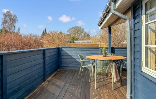 a patio with a table and chairs on a deck at 2 Bedroom Amazing Home In Slagelse in Slagelse