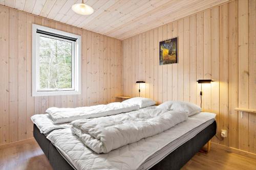 a large bed in a room with a window at 127-Ringkobing-Birkealle-1 in Nørby