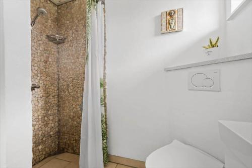 a bathroom with a shower with a toilet in it at 286-Ringkobing-Vestklitvej-14 in Klegod