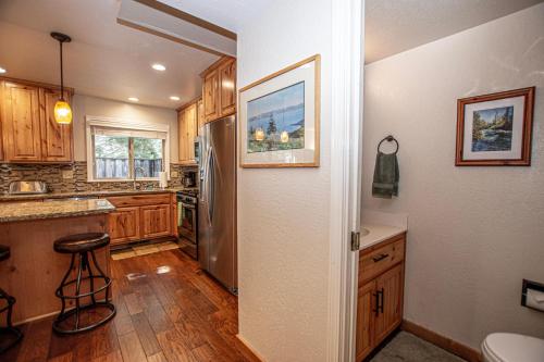 a kitchen with wooden cabinets and a stainless steel refrigerator at Lake Forest Glen # 142 in Tahoe City