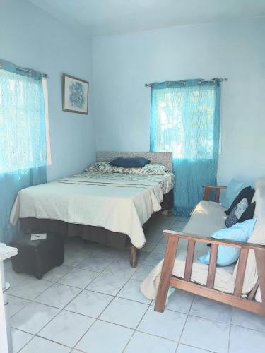 a room with two beds and a bench in it at Powell's guesthouse in Santa Cruz