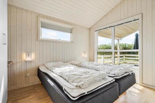 a bed in a room with a window at 120-Ringkobing-Sletten-15 in Søndervig