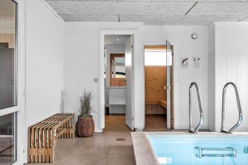 a bathroom with a blue tub in a room at 292-Ringkobing-Vestklitvej-12 in Klegod