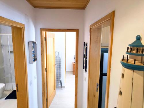 a hallway with two doors leading to a bathroom at Seaview Varandas do Sol 2 in Portimão