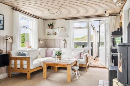 a living room with a white couch and a table at 1165-Ringkobing-Lodbergsvej-119 in Søndervig