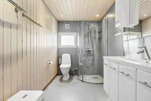 a bathroom with a shower and a toilet and a sink at 268-Ringkobing-Lyngvejen-63 in Klegod