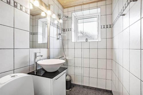 a white bathroom with a sink and a toilet at 138-Ringkobing-Sondervig-Klitvej-3 in Søndervig