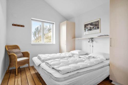 a large white bed in a room with a window at 1177-Ringkobing-Anders-Juhls-Vej-10 in Søndervig