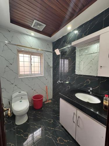 a bathroom with a toilet and a sink at 6-BedRoom house in Bahria in Lahore