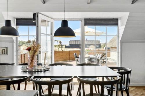 a dining room with a table and chairs at 2227-Ringkobing-Fladsbjergvej-116 in Klegod
