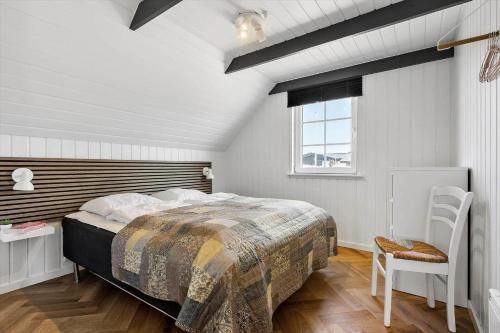 a bedroom with a large bed and a window at 2227-Ringkobing-Fladsbjergvej-116 in Klegod